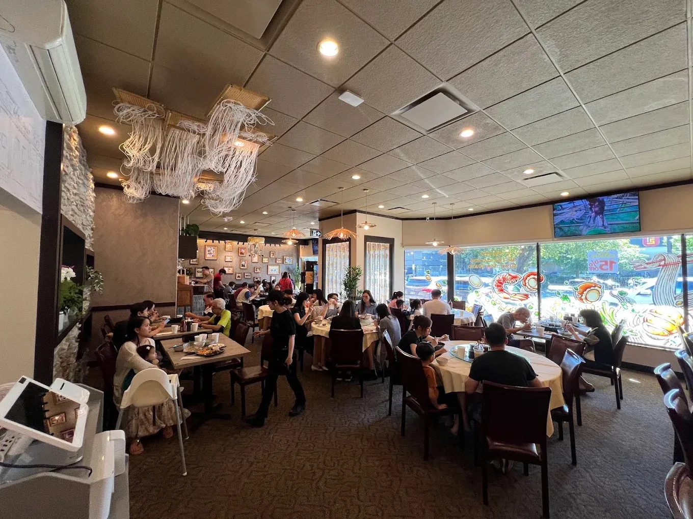The Richmond dining room full of guests at round and square tables