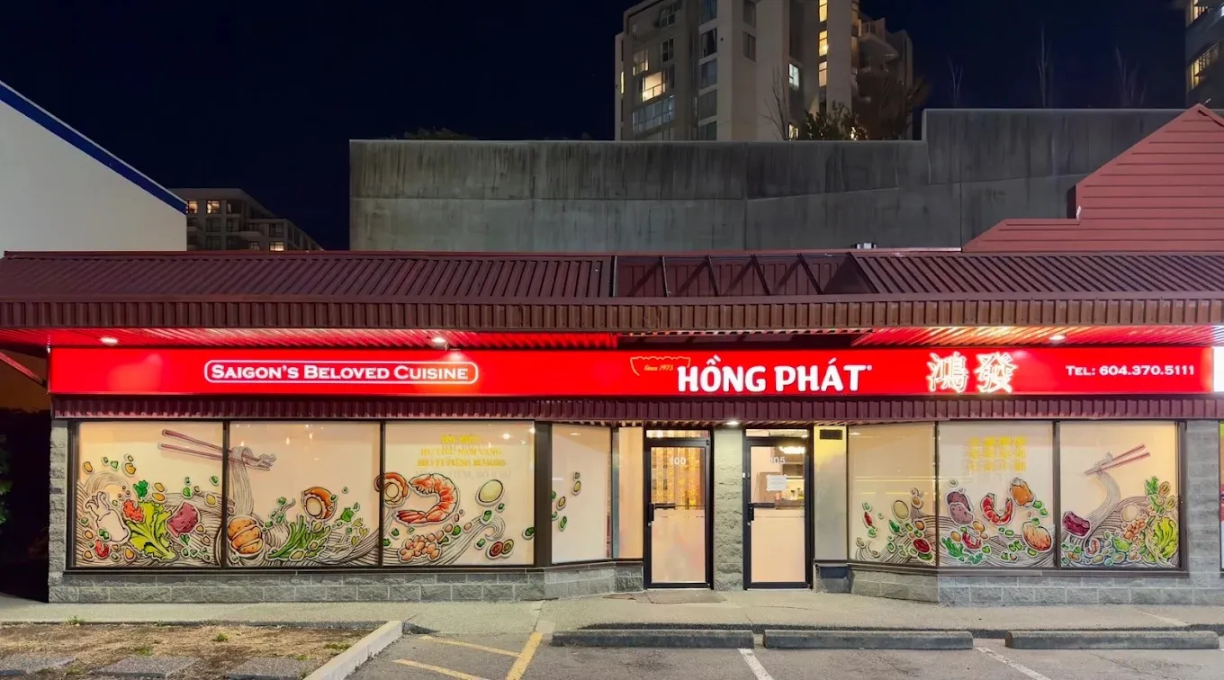 The Richmond storefront at night under its glowing red Hồng Phát sign